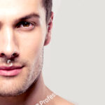 stock-photo-handsome-young-man-with-nude-torso-looking-at-camera-over-gray-background-287947118